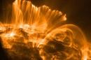 Orange flares of light erupt from the surface of the sun.